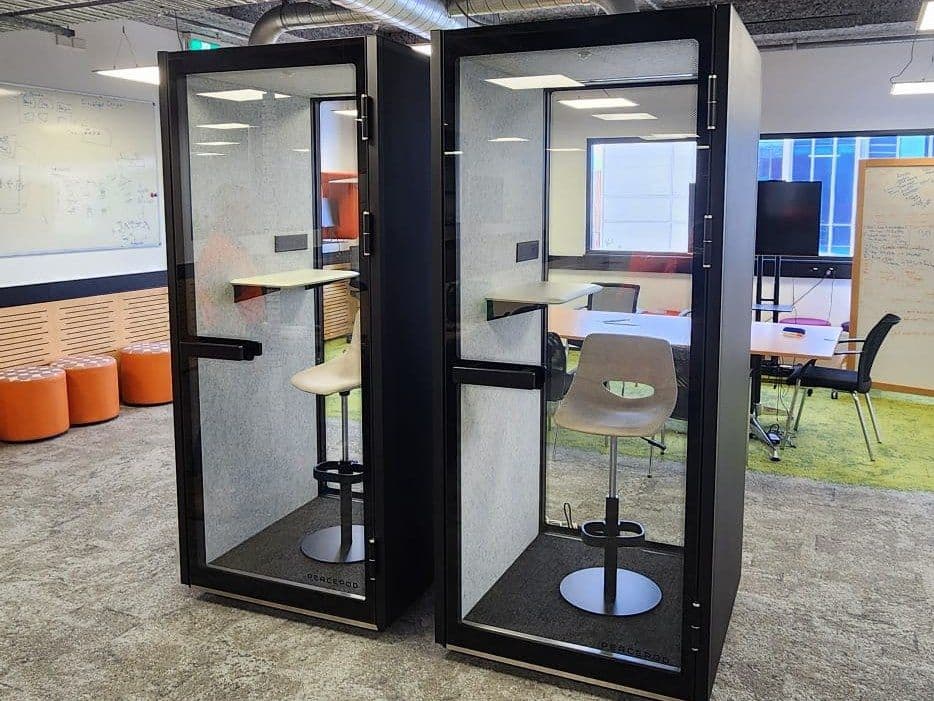 Two Peacepod booths installed side by side in a client office